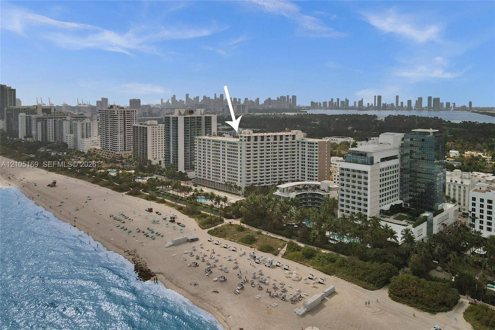 2899 Collins Avenue, #521, Miami Beach, FL 33140 Aerial perspective showcasing a high-rise building with a cityscape background and adjacent beachfront