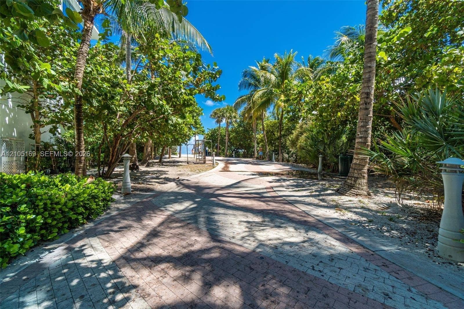 2899 Collins Avenue, #521, Miami Beach, FL 33140 Paver pathway with lush landscaping and mature palm trees