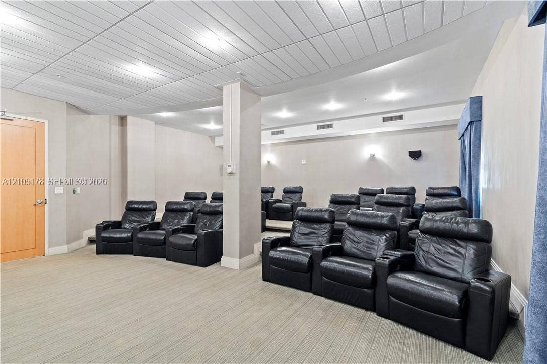 3801 S Ocean Drive, #10G, Hollywood, Hollywood, FL 33019 Tiered seating area featuring recessed lighting, a paneled ceiling, and neutral wall tones
