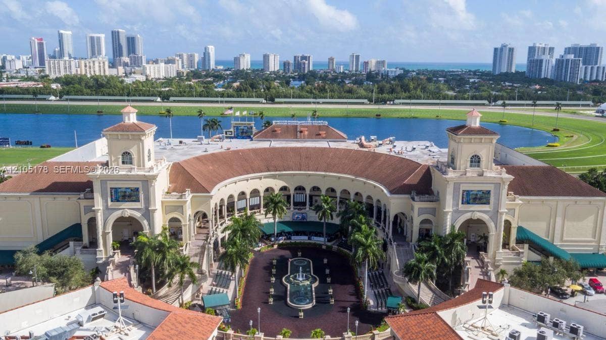 3801 S Ocean Drive, #10G, Hollywood, Hollywood, FL 33019 Mediterranean-inspired architecture featuring dual towers, arched entryways, a central courtyard fountain, and terracotta roofing