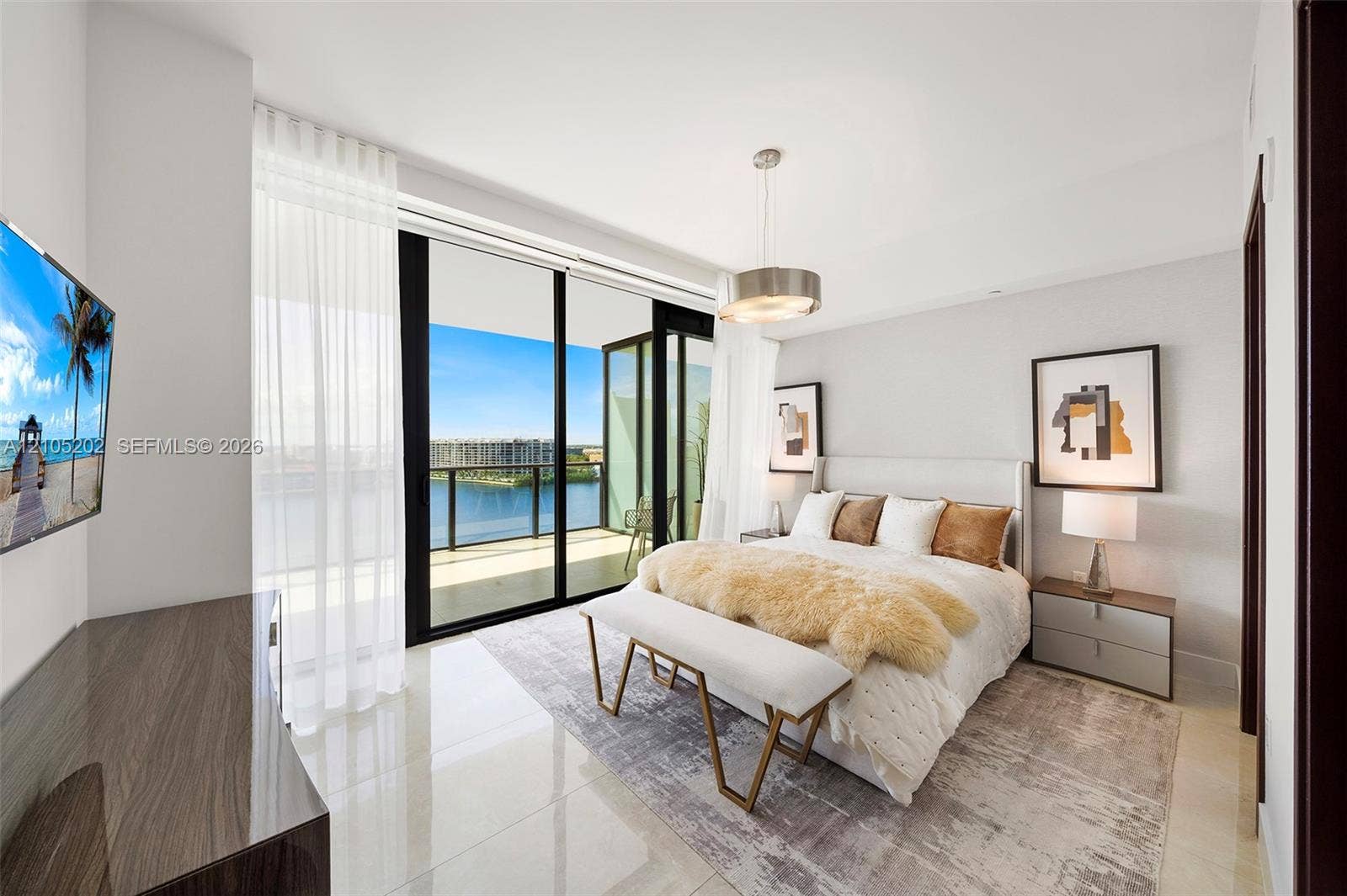 Floor-to-ceiling glass sliding doors opening to a balcony, polished tile flooring, pendant lighting, and neutral wall tones