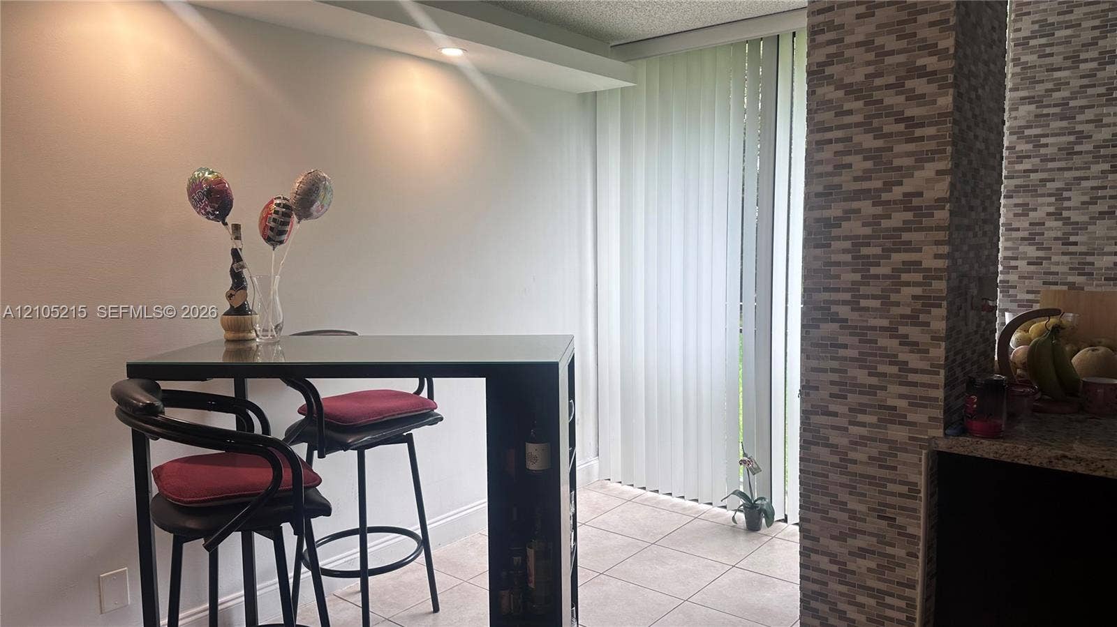 17021 N Bay Road, #114, Sunny Isles Beach, Sunny Isles Beach, FL 33160 Vertical blind window treatment, textured tile accent wall, recessed ceiling lighting, and ceramic tile flooring
