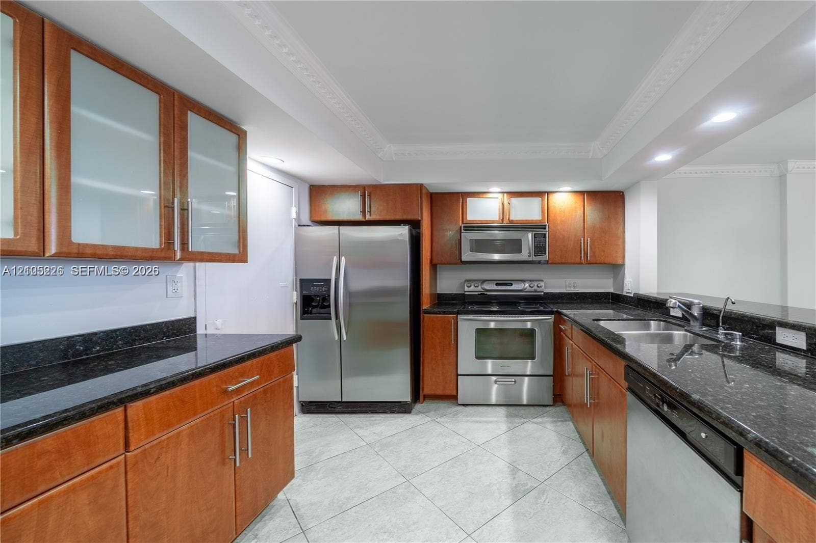 3800 S Ocean Drive, #801, Hollywood, Hollywood, FL 33019 Kitchen featuring wood cabinetry, stone countertops, stainless steel appliances, and tile flooring