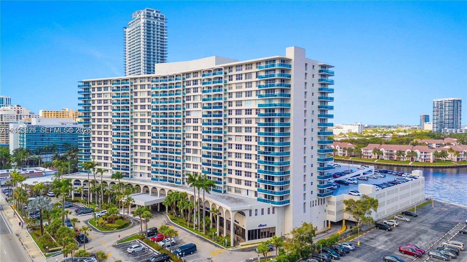 3800 S Ocean Drive, #801, Hollywood, Hollywood, FL 33019 Aerial perspective featuring a multi-story residential building with private pool, direct water frontage, and surrounding coastal infrastructure