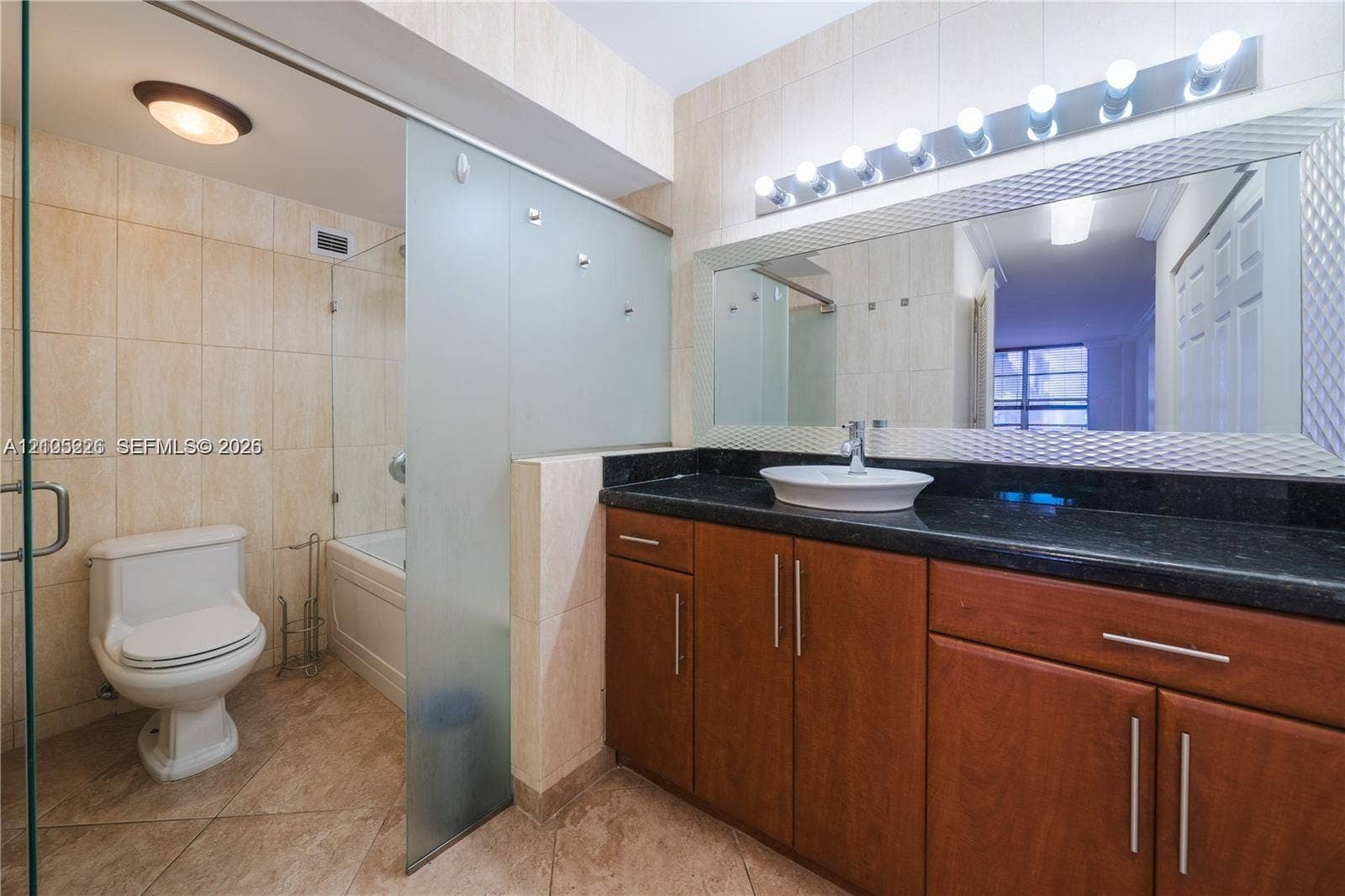 3800 S Ocean Drive, #801, Hollywood, Hollywood, FL 33019 Covered balcony featuring glass pane railings and concrete flooring, overlooking the canal and surrounding cityscape