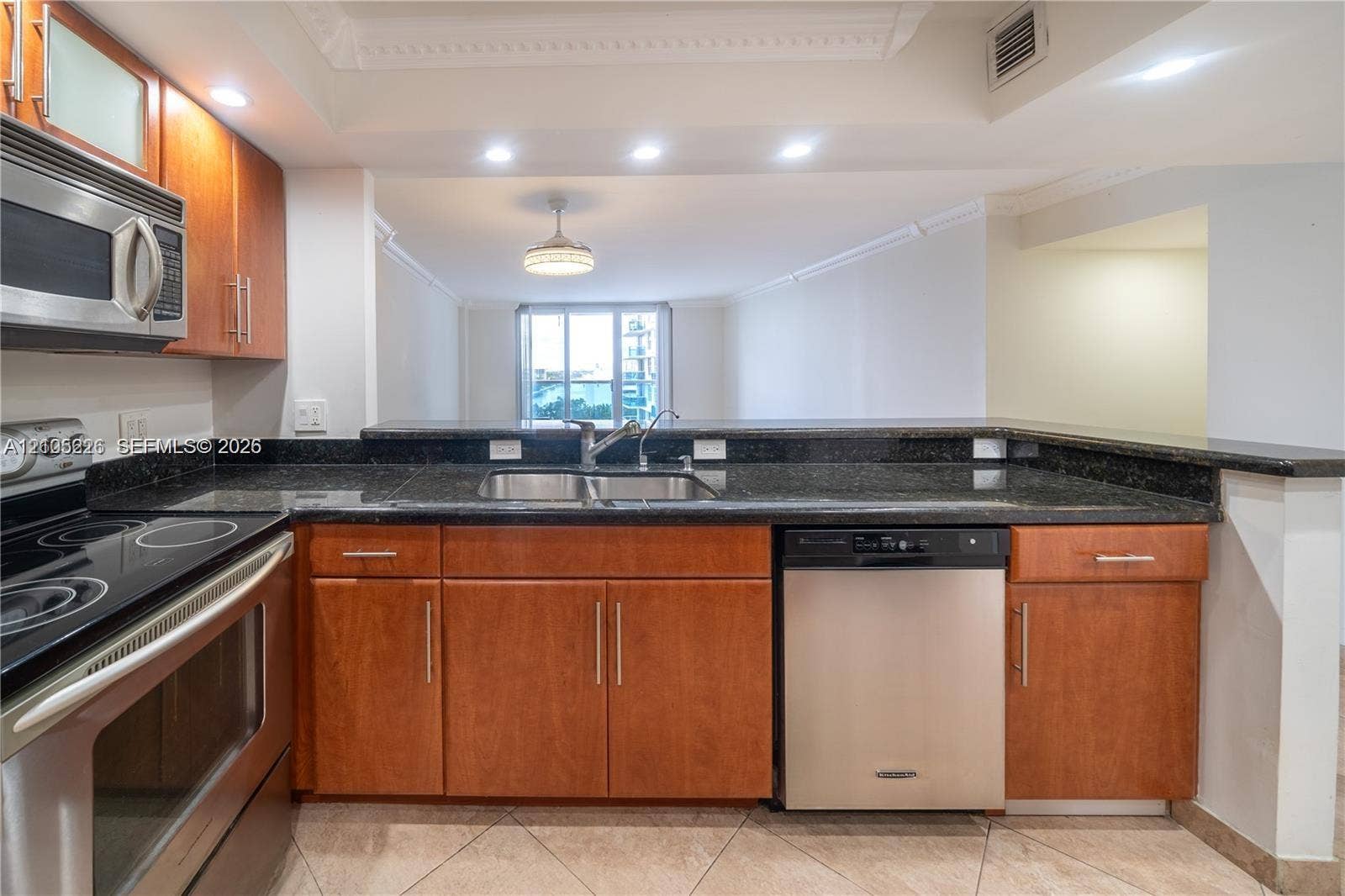3800 S Ocean Drive, #801, Hollywood, Hollywood, FL 33019 Kitchen featuring wood-finish cabinetry, stone-surface countertops, stainless steel appliances, tile flooring, and recessed lighting