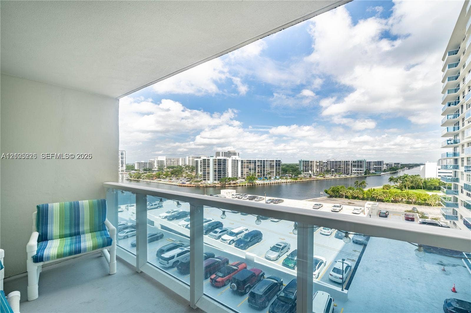 3800 S Ocean Drive, #801, Hollywood, Hollywood, FL 33019 Grand lobby featuring polished stone flooring with geometric tile inlays, a central mirrored support pillar, a recessed circular tray ceiling with integrated lighting, and wall-mounted sconces