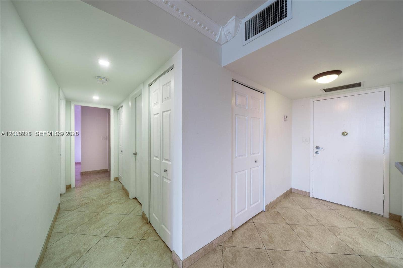 3800 S Ocean Drive, #801, Hollywood, Hollywood, FL 33019 Wood-toned cabinetry featuring a dark stone countertop, a white vessel sink, a large wood-framed wall mirror, and a glass-enclosed shower with tile surround