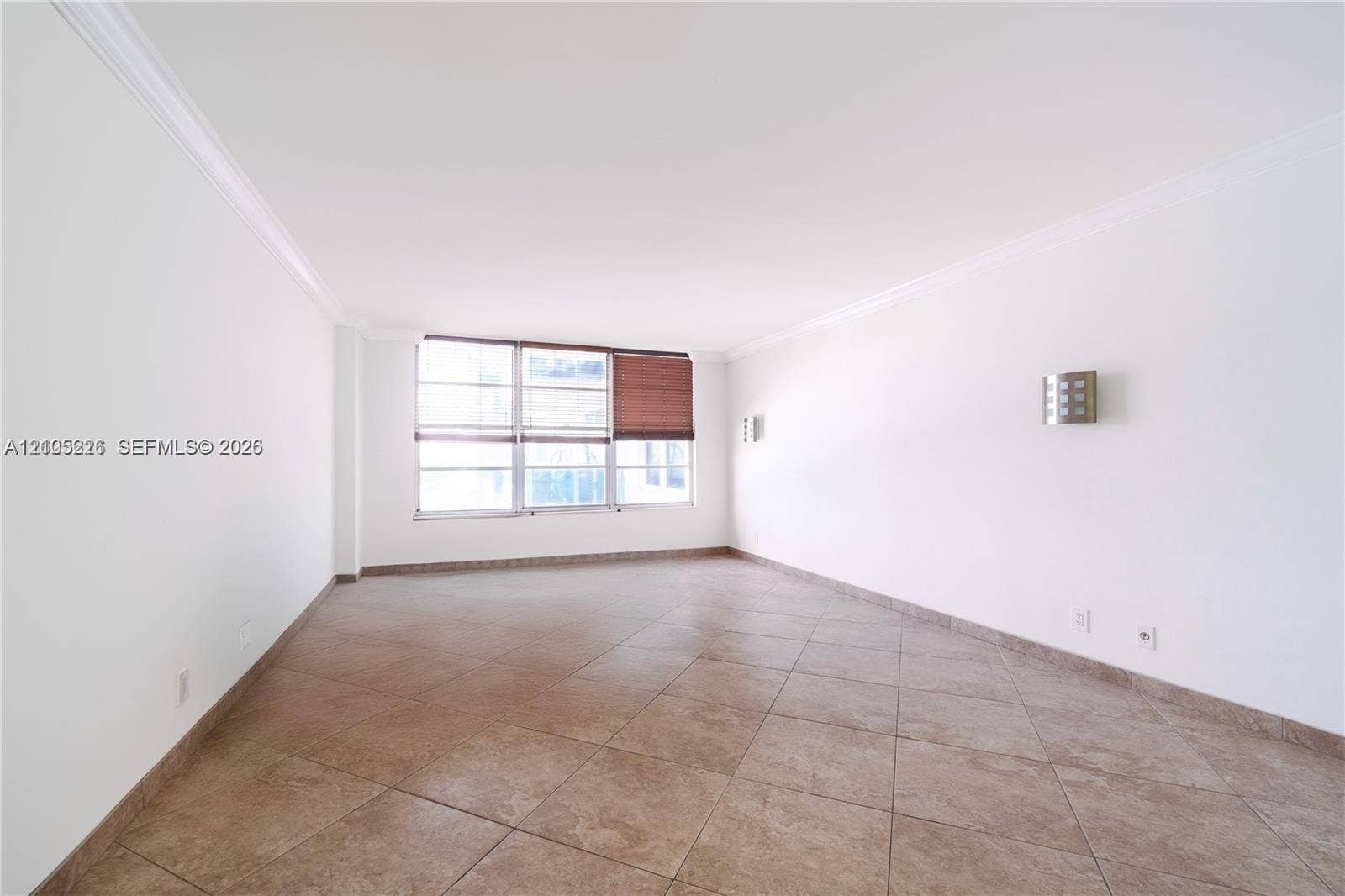 3800 S Ocean Drive, #801, Hollywood, Hollywood, FL 33019 Walk-in closet featuring white built-in shelving, vanity with dark countertop and vessel sink, large wall-mounted mirror with integrated lighting, and tile flooring