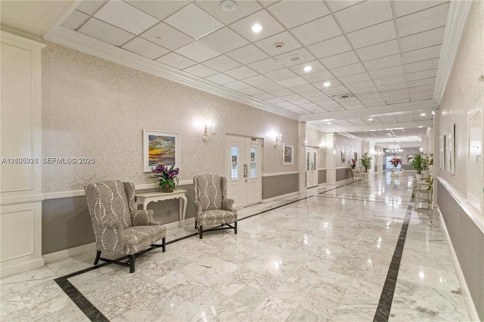 3800 S Ocean Drive, #801, Hollywood, Hollywood, FL 33019 Recessed ceiling lighting, patterned wall-to-wall carpeting, two-toned wall finishes with chair rail molding, and a suspended stained-glass style pendant light
