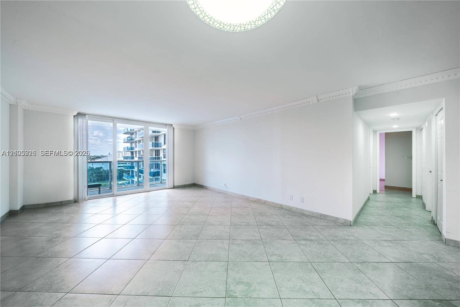 3800 S Ocean Drive, #801, Hollywood, Hollywood, FL 33019 Entryway featuring light-toned tile flooring, crown molding, and multiple paneled interior doors