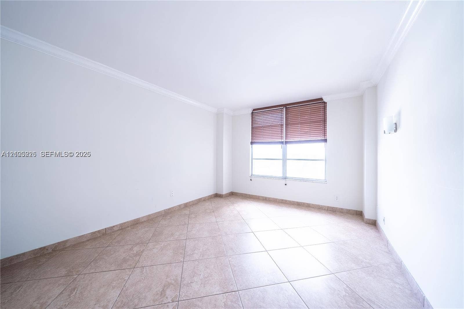 3800 S Ocean Drive, #801, Hollywood, Hollywood, FL 33019 Open-concept interior featuring oversized tile flooring, crown molding, and expansive multi-pane windows with built-in wall-mounted light fixtures