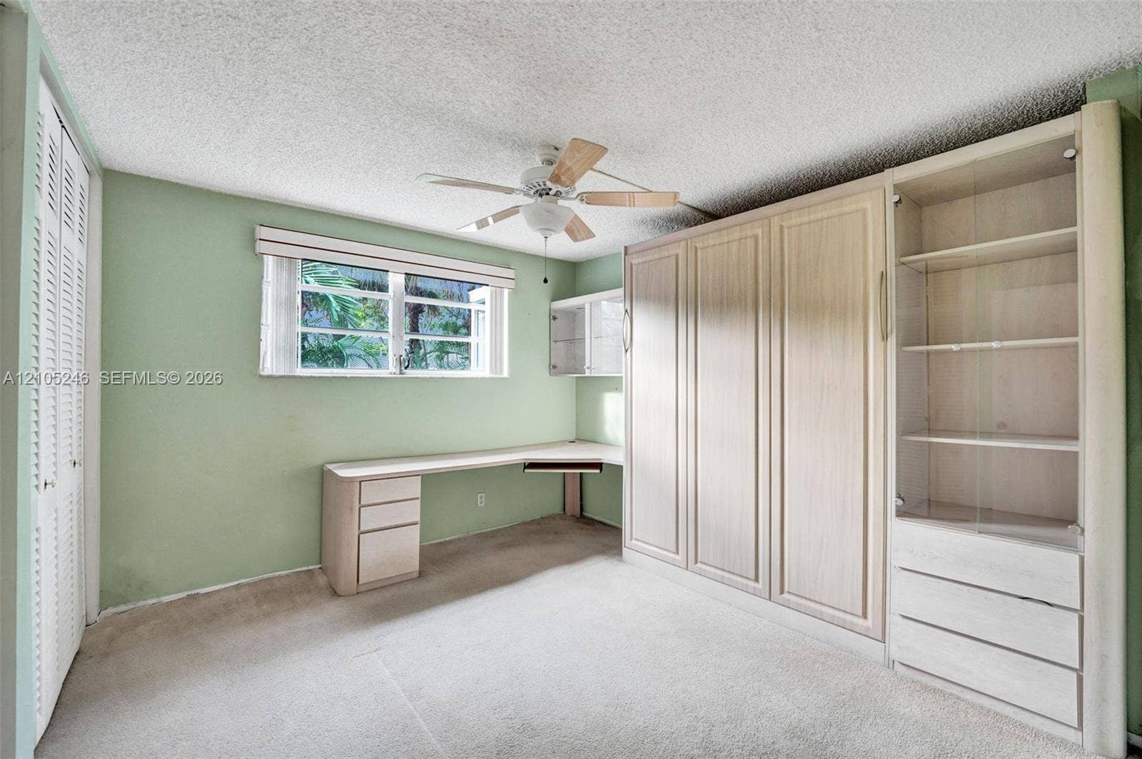 1400 Tallwood Avenue, #207, Hollywood, FL 33021 Built-in light-tone wood cabinetry with integrated shelving, desk surface, and drawers