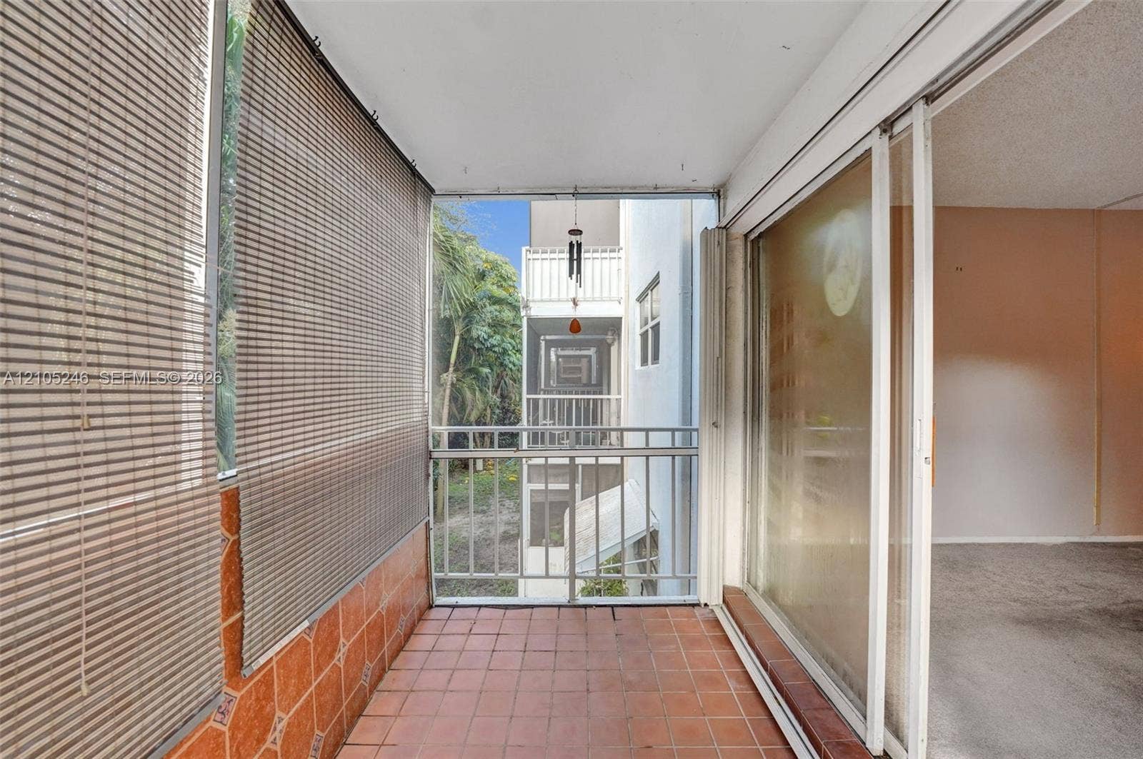1400 Tallwood Avenue, #207, Hollywood, FL 33021 Enclosed balcony featuring ceramic tile flooring, horizontal window shades, and metal railings
