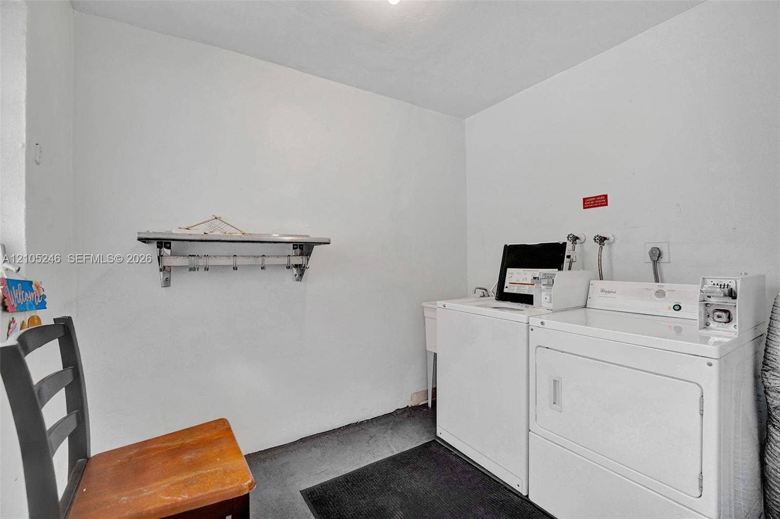 1400 Tallwood Avenue, #207, Hollywood, FL 33021 Dedicated laundry area featuring a wall-mounted shelving unit and a built-in utility sink