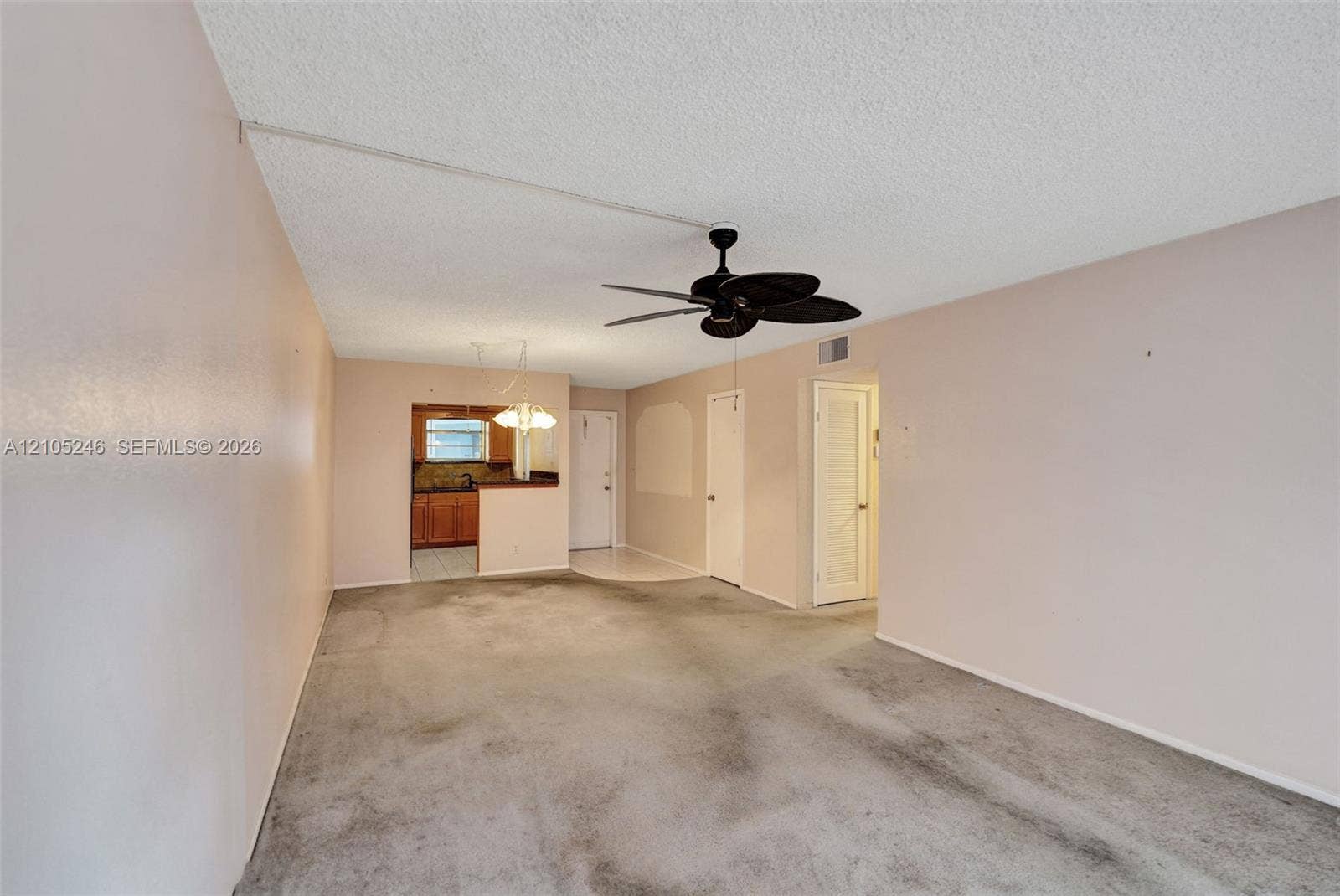 1400 Tallwood Avenue, #207, Hollywood, FL 33021 Living area featuring a ceiling fan with integrated lighting, neutral wall paint, and interior doors
