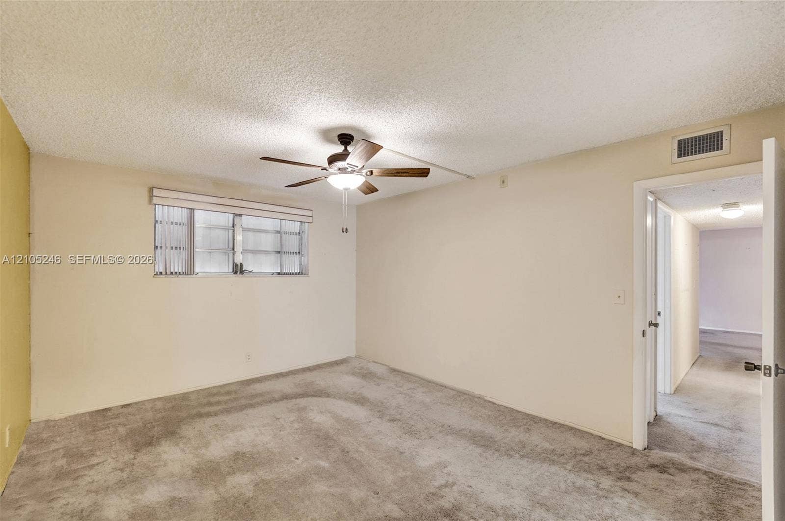 1400 Tallwood Avenue, #207, Hollywood, FL 33021 Room featuring wall-to-wall carpeting, a ceiling fan with integrated lighting, and a multi-pane horizontal window