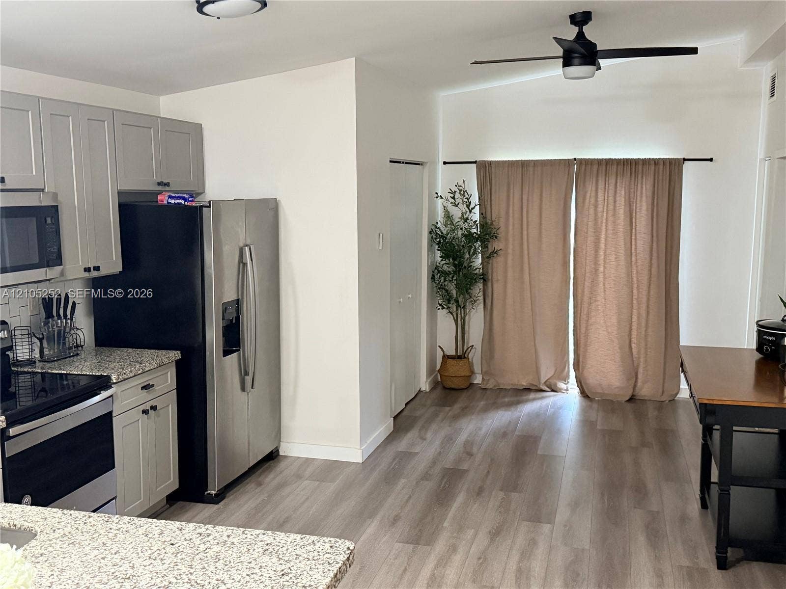 700 NW 17th Terrace, Pompano Beach, FL 33069 Kitchen featuring light gray cabinetry, stainless steel appliances, and a tile backsplash