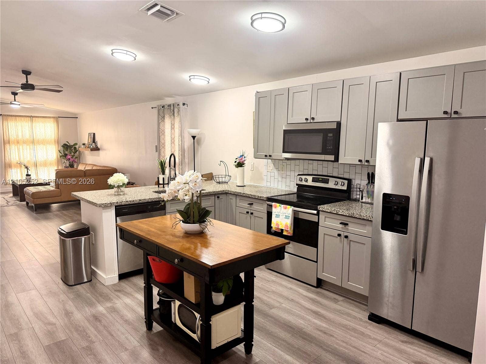700 NW 17th Terrace, Pompano Beach, FL 33069 Kitchen featuring gray cabinetry, stainless steel appliances, and light-toned countertops