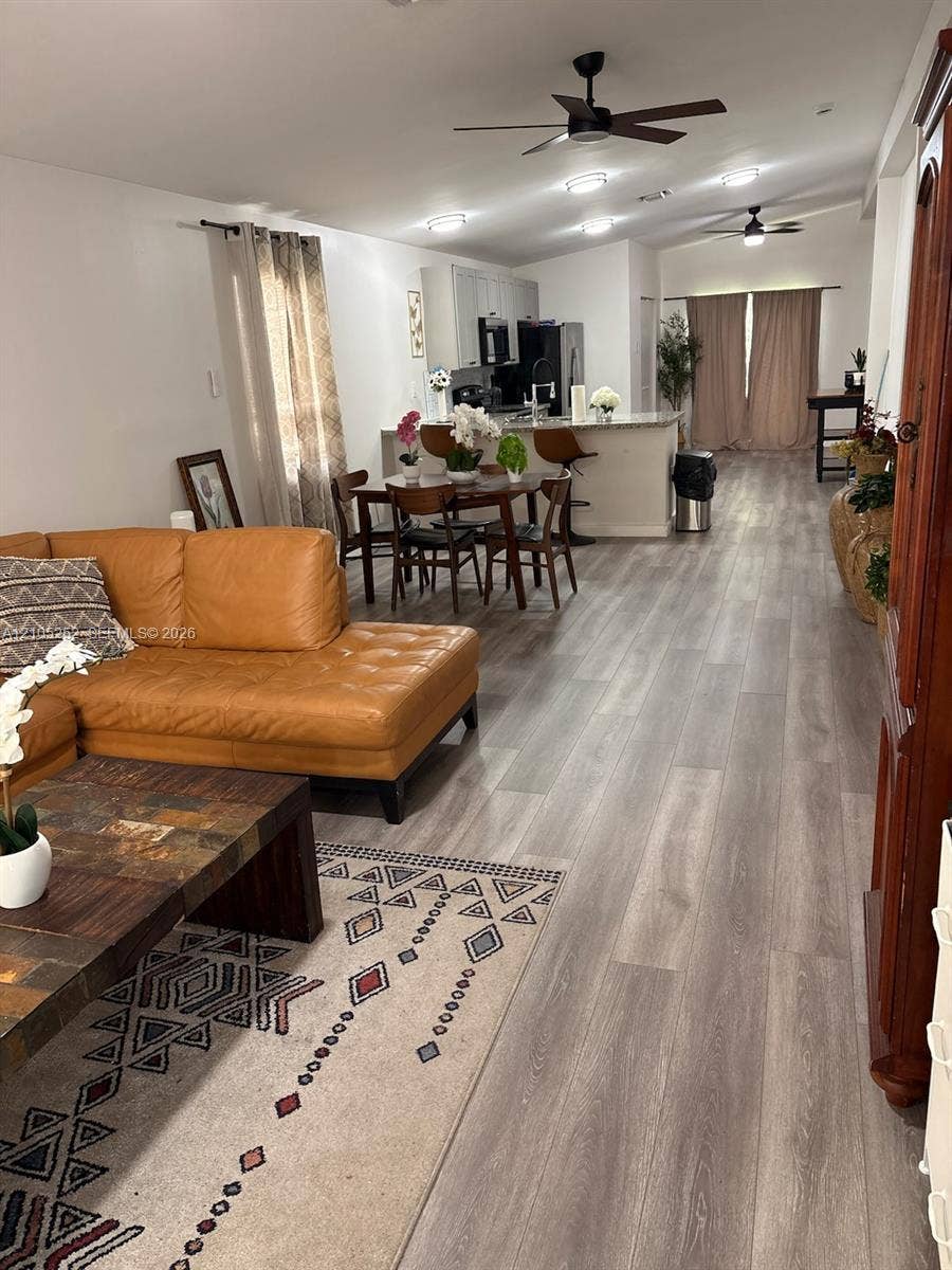 700 NW 17th Terrace, Pompano Beach, FL 33069 Open-concept living area featuring wood-finish flooring, recessed lighting, and ceiling fans
