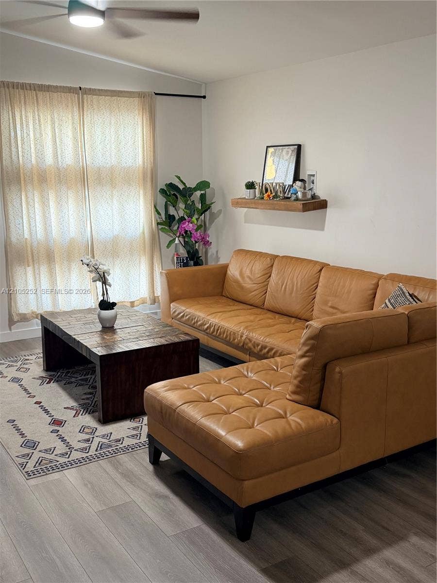 700 NW 17th Terrace, Pompano Beach, FL 33069 Wood-finish flooring, light-toned walls, and a ceiling fan with integrated lighting