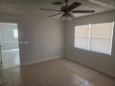2208 Garfield Street, #B, Hollywood, Hollywood, FL 33020 Tile flooring, window with blinds, ceiling fan with light fixture, and white painted walls
