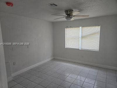 2208 Garfield Street, #B, Hollywood, Hollywood, FL 33020 White tile flooring, dual windows with blinds, and a ceiling fan with integrated lighting