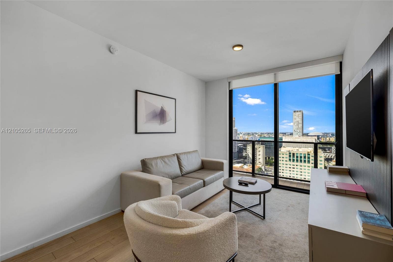 398 NE 5th Street, #2219, Miami, FL 33132 Floor-to-ceiling windows, wood-finish flooring, and built-in vertical slat paneling