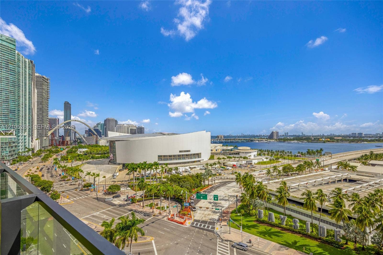 398 NE 5th Street, #2219, Miami, FL 33132 Private balcony with glass railing overlooking the urban skyline, waterfront, and surrounding park landscape