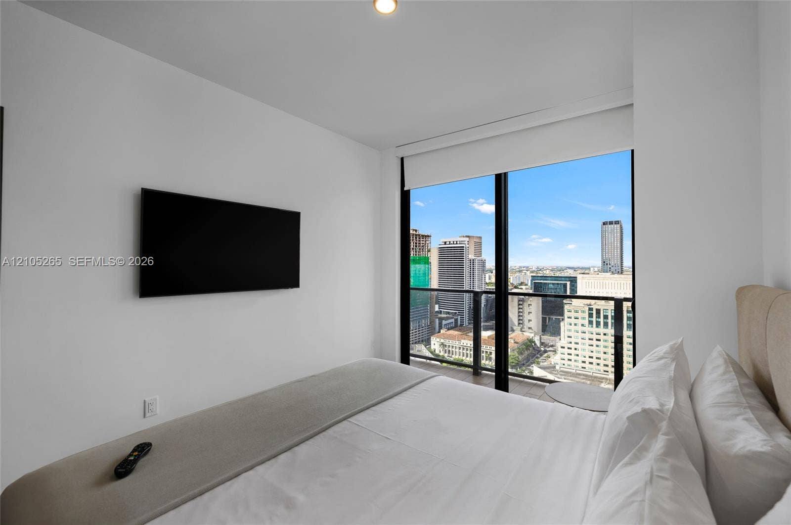 398 NE 5th Street, #2219, Miami, FL 33132 Floor-to-ceiling windows featuring urban skyline scenery and an attached glass-railing balcony
