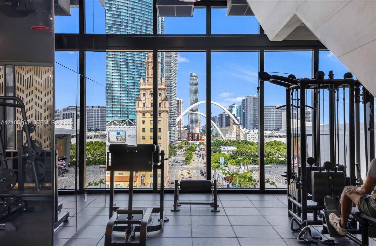 398 NE 5th Street, #2219, Miami, FL 33132 Fitness center featuring floor-to-ceiling windows, panoramic urban skyline scenery, and large-format tile flooring