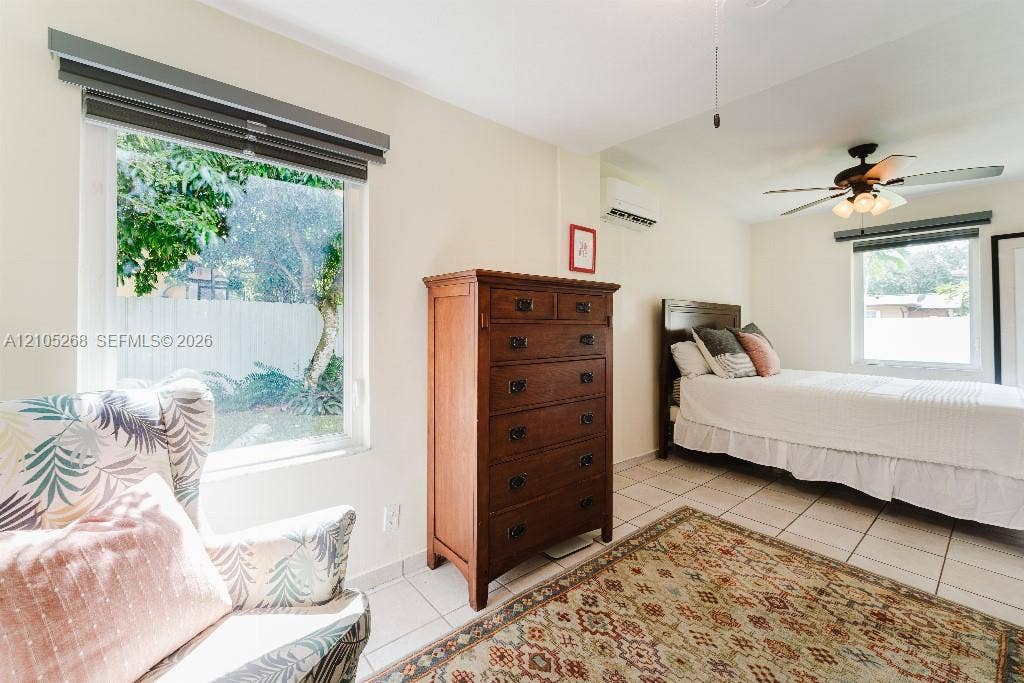 230 Miami Springs Avenue, Miami Springs, FL 33166 Tile flooring, ceiling fan with integrated lighting, split air conditioning system, and window with privacy blinds