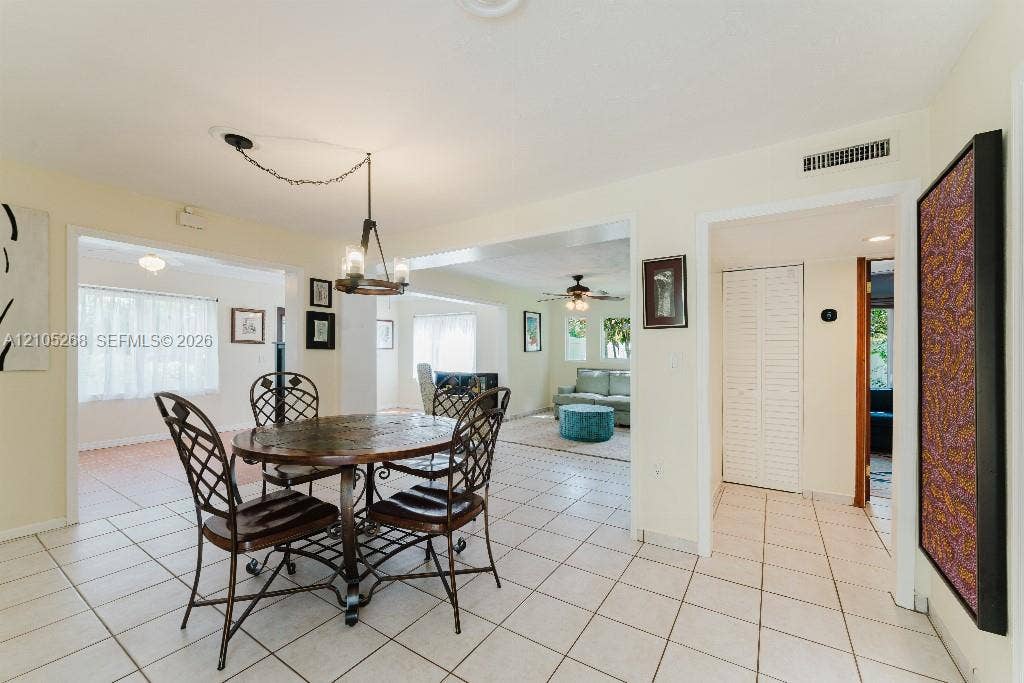 230 Miami Springs Avenue, Miami Springs, FL 33166 Tile flooring extends throughout this space, featuring an exposed beam ceiling and recessed lighting