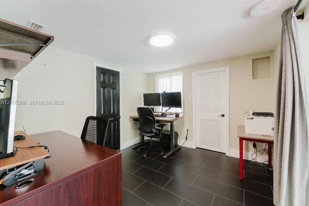 230 Miami Springs Avenue, Miami Springs, FL 33166 Black tile flooring, recessed lighting, and light neutral wall finishes