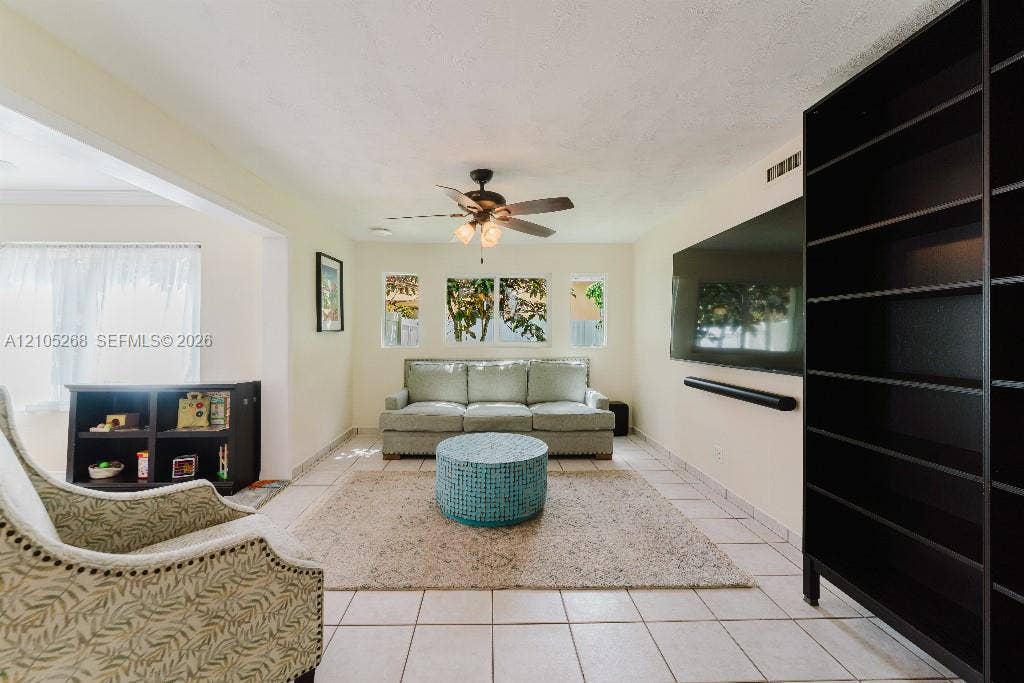 230 Miami Springs Avenue, Miami Springs, FL 33166 White tile flooring, ceiling fan, recessed lighting, and built-in shelving