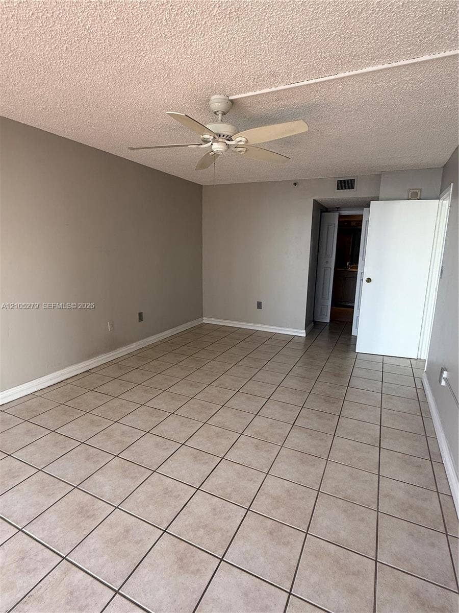 Neutral-toned tile flooring throughout