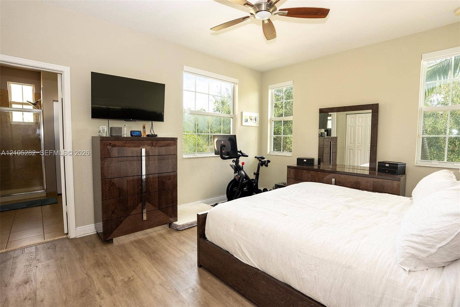 1104 SW 146th Terrace, Pembroke Pines, FL 33027 Room featuring wood-finish flooring, multi-pane windows, and a ceiling fan