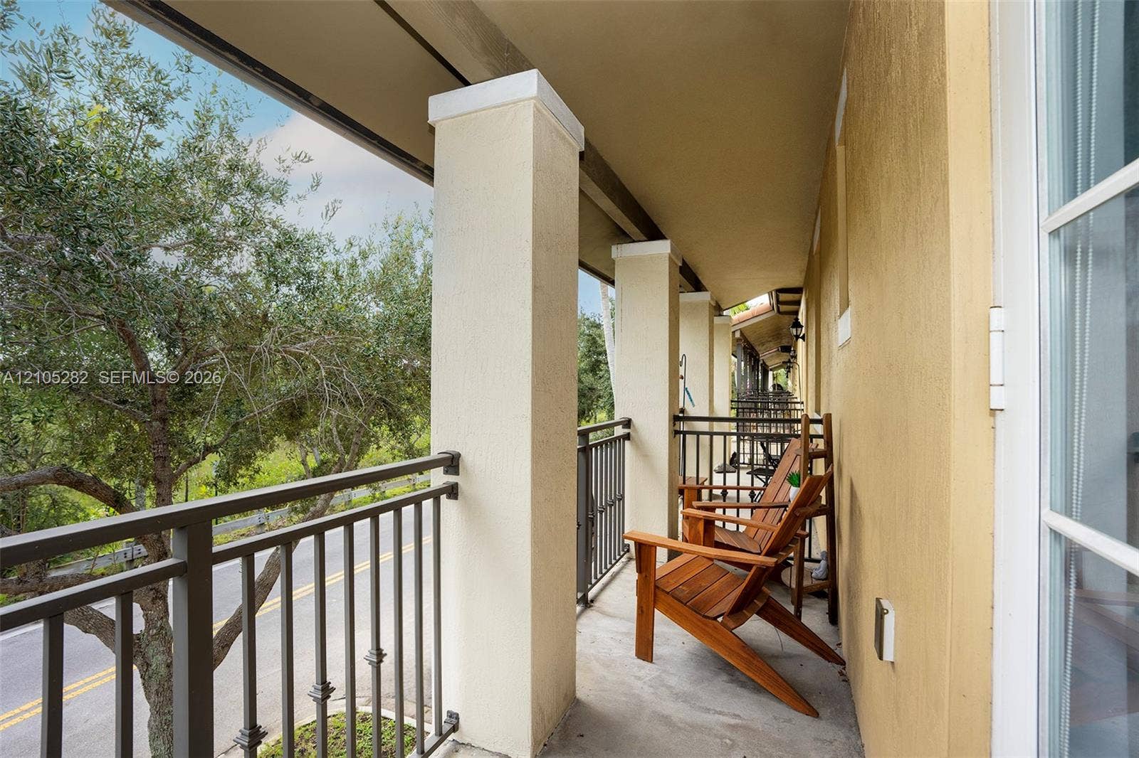1104 SW 146th Terrace, Pembroke Pines, FL 33027 Covered balcony featuring concrete flooring, structural square columns, and a metal railing