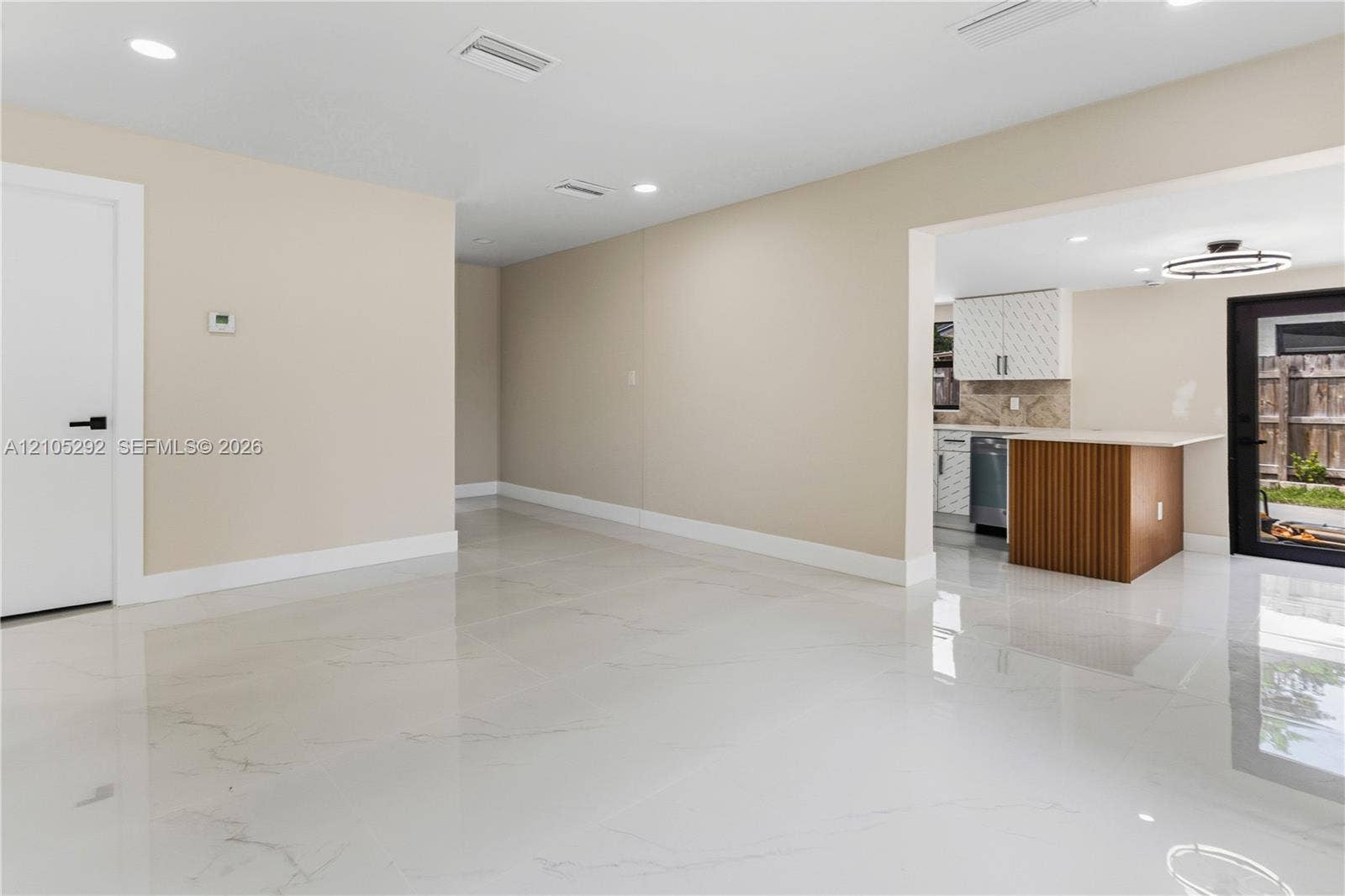 Polished tile flooring, recessed lighting, and a modern open concept layout