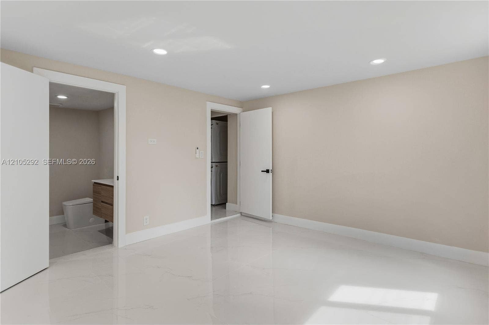 Polished tile flooring, recessed lighting, and a neutral wall color