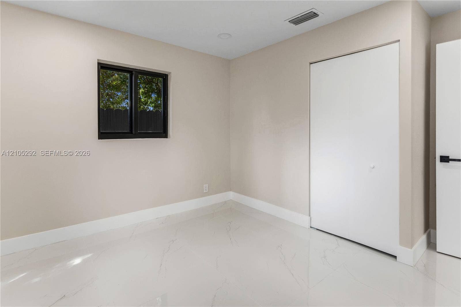White tile flooring, neutral wall tones, bi-fold closet doors, and recessed lighting