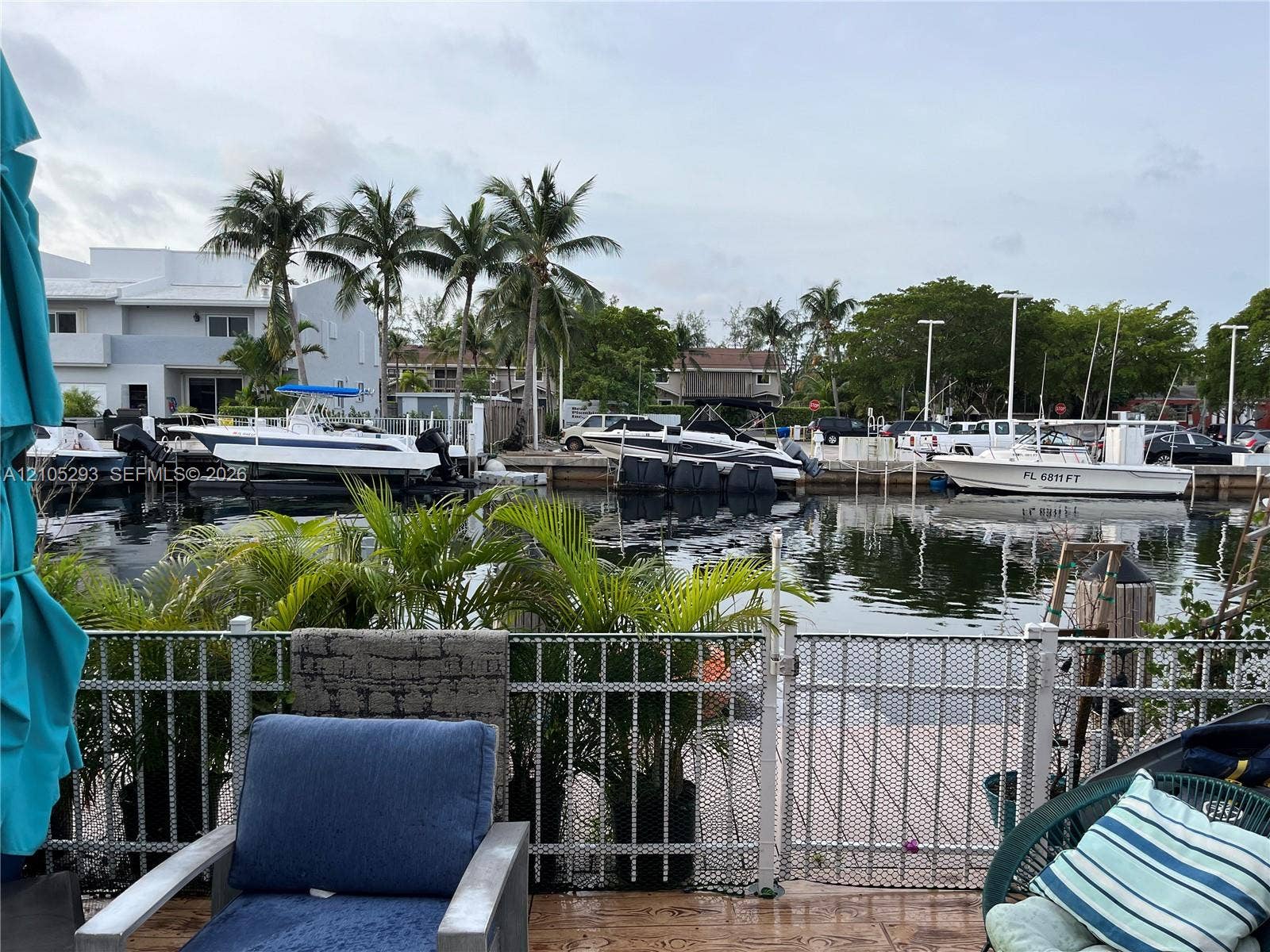 3792 NE 167th Street, #50, North Miami Beach, FL 33160 Waterfront property featuring a private boat slip, dockage with mooring posts, and metal perimeter fencing