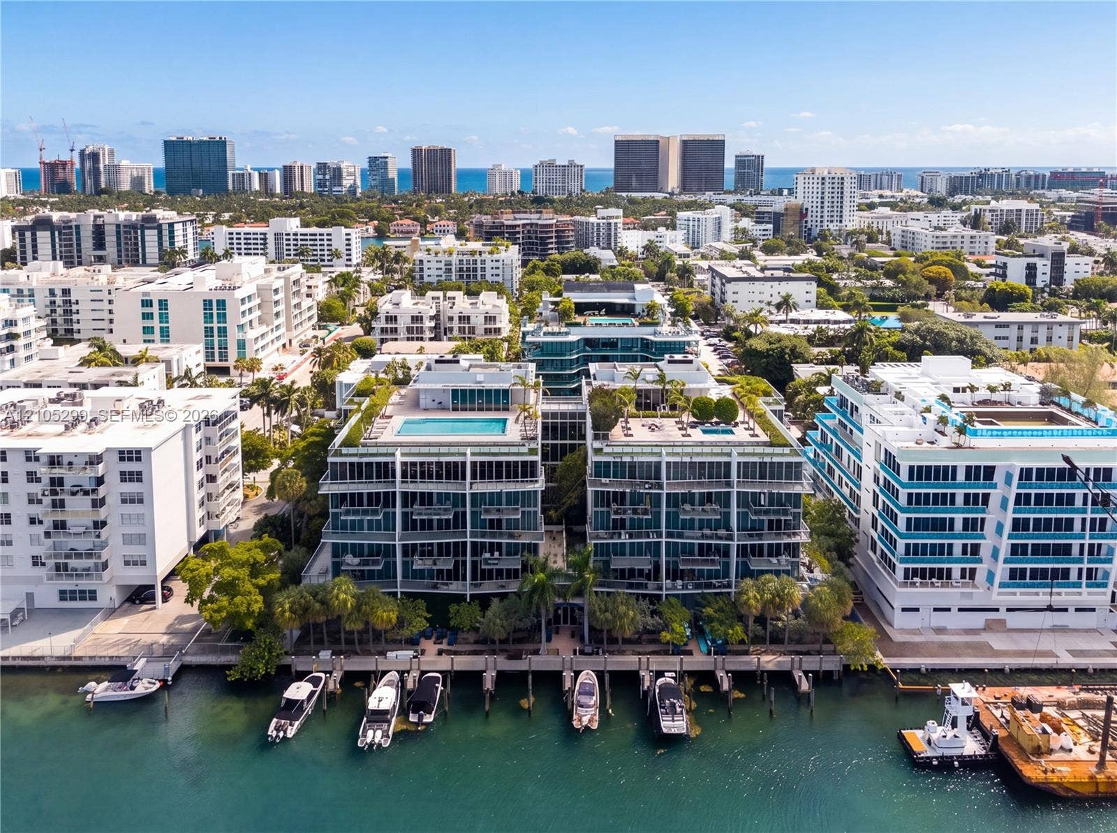 Waterfront residential buildings featuring private boat slips, rooftop pools, and balconies