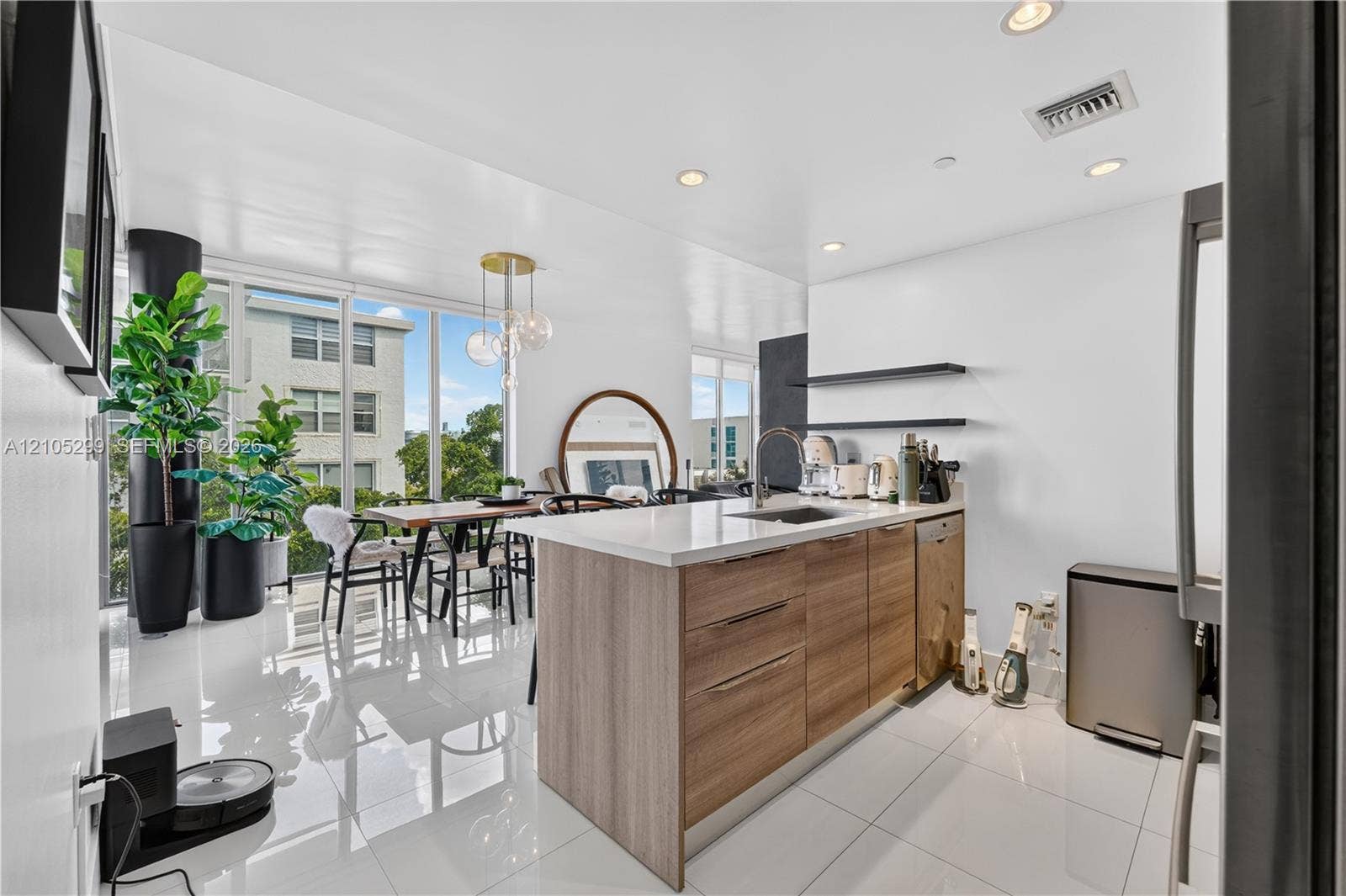Modern kitchen island with wood-finish cabinetry and white countertop