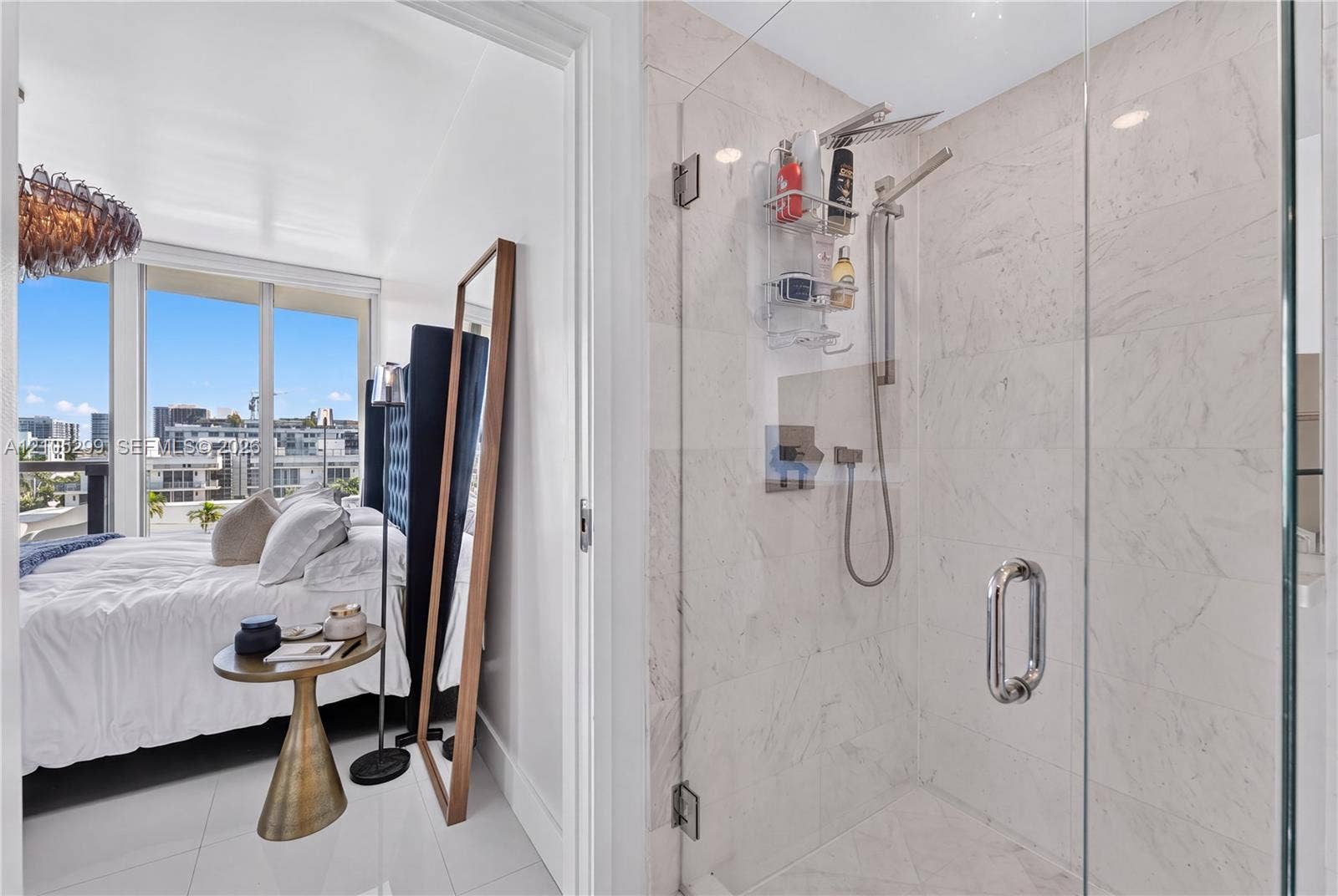 Glass-enclosed shower with a handheld spray and rainfall showerhead, white tile surround, and polished chrome fixtures