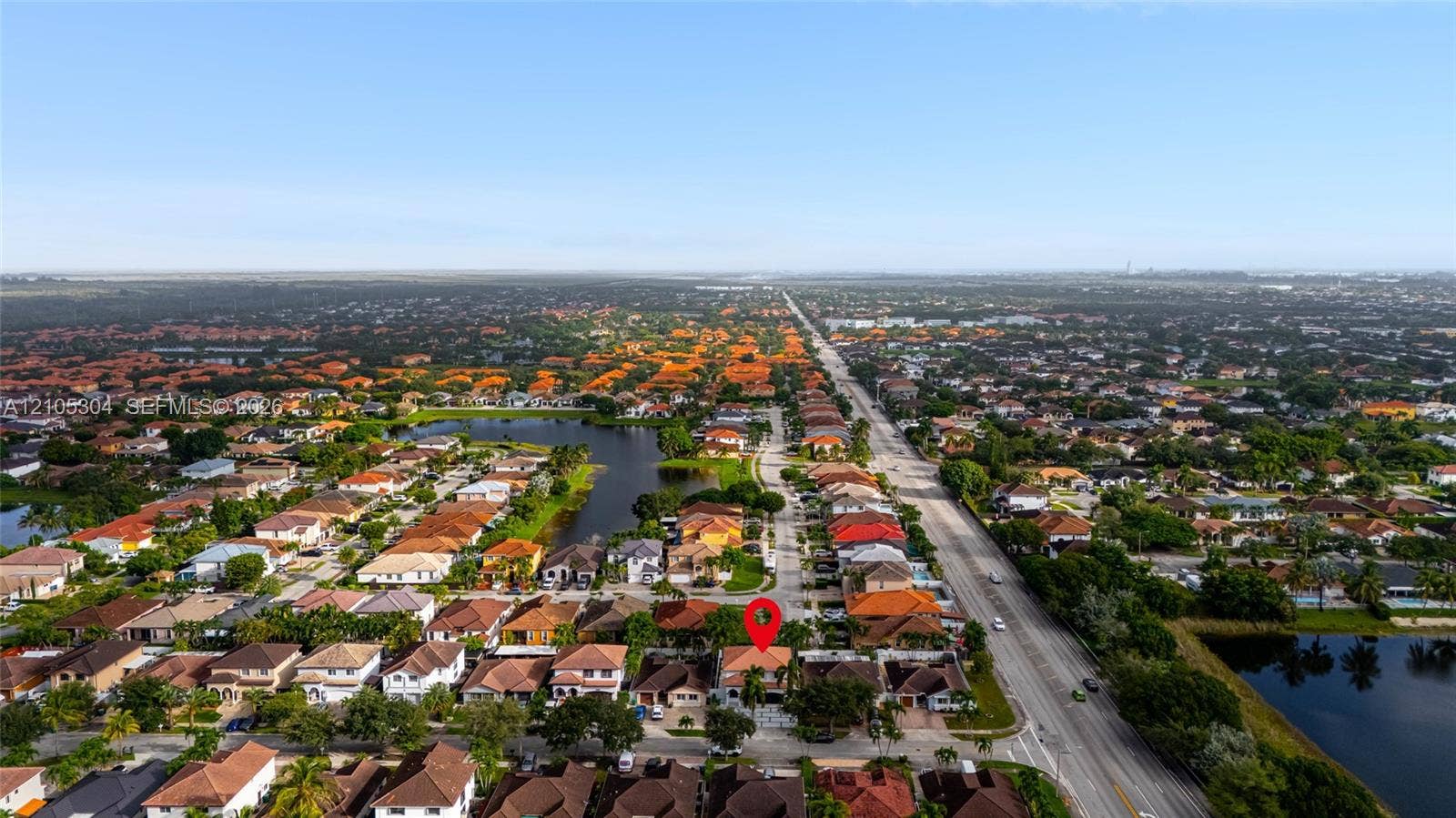 15217 SW 36th Terrace, Miami, FL 33185 Aerial perspective of a residential neighborhood featuring multiple ponds and expansive surrounding landscape
