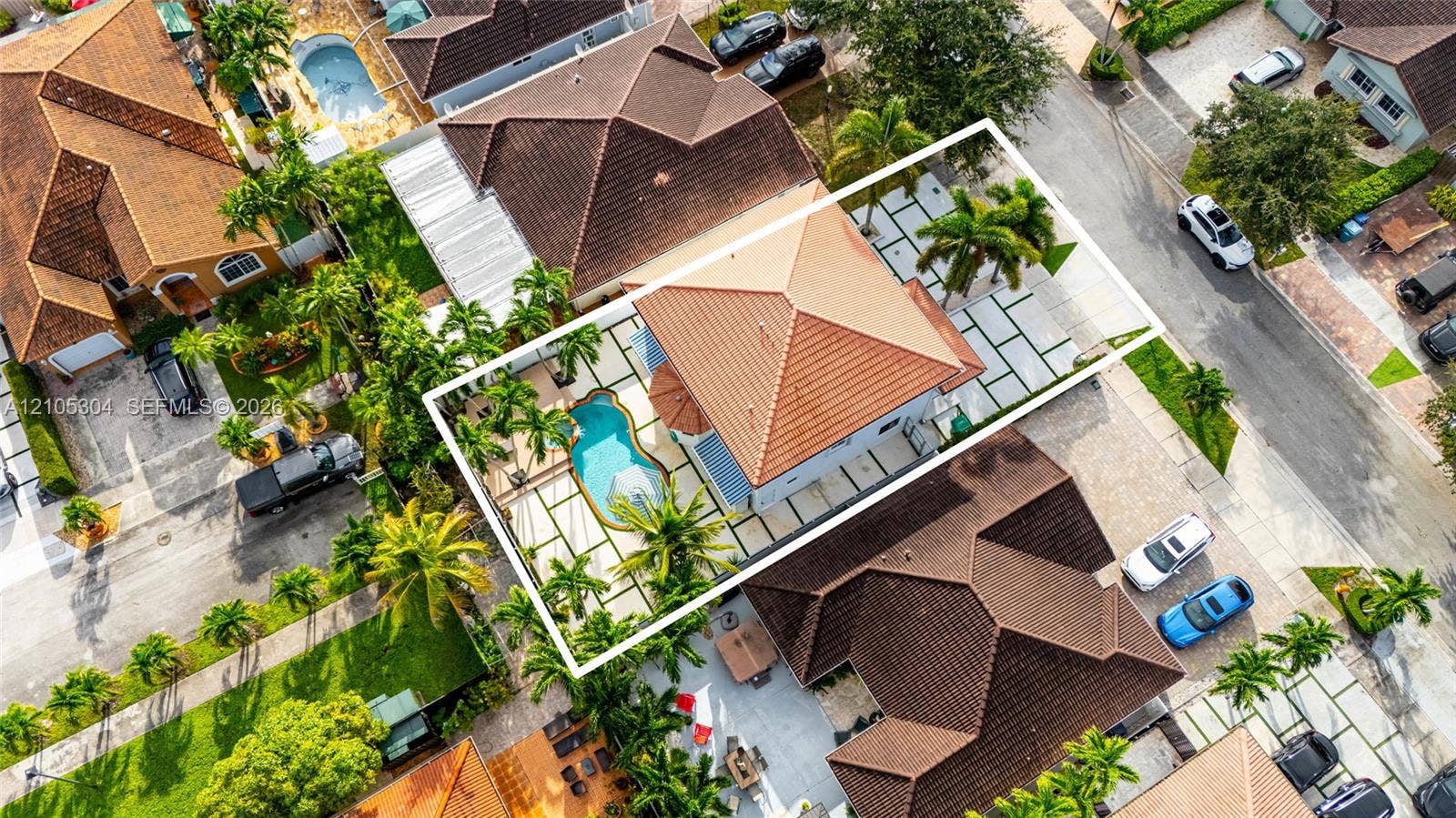 15217 SW 36th Terrace, Miami, FL 33185 Aerial perspective featuring a tile roof, an in-ground swimming pool, and geometric paver hardscaping