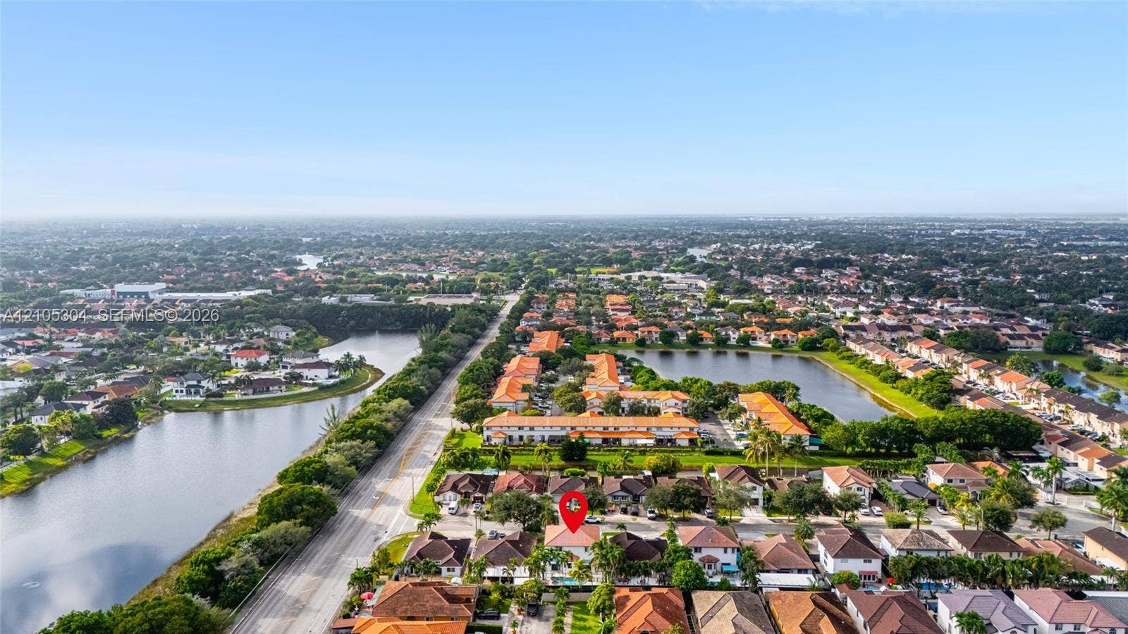 15217 SW 36th Terrace, Miami, FL 33185 Aerial perspective of a residential property featuring a tiled roof, multi-car garage, and an in-ground swimming pool