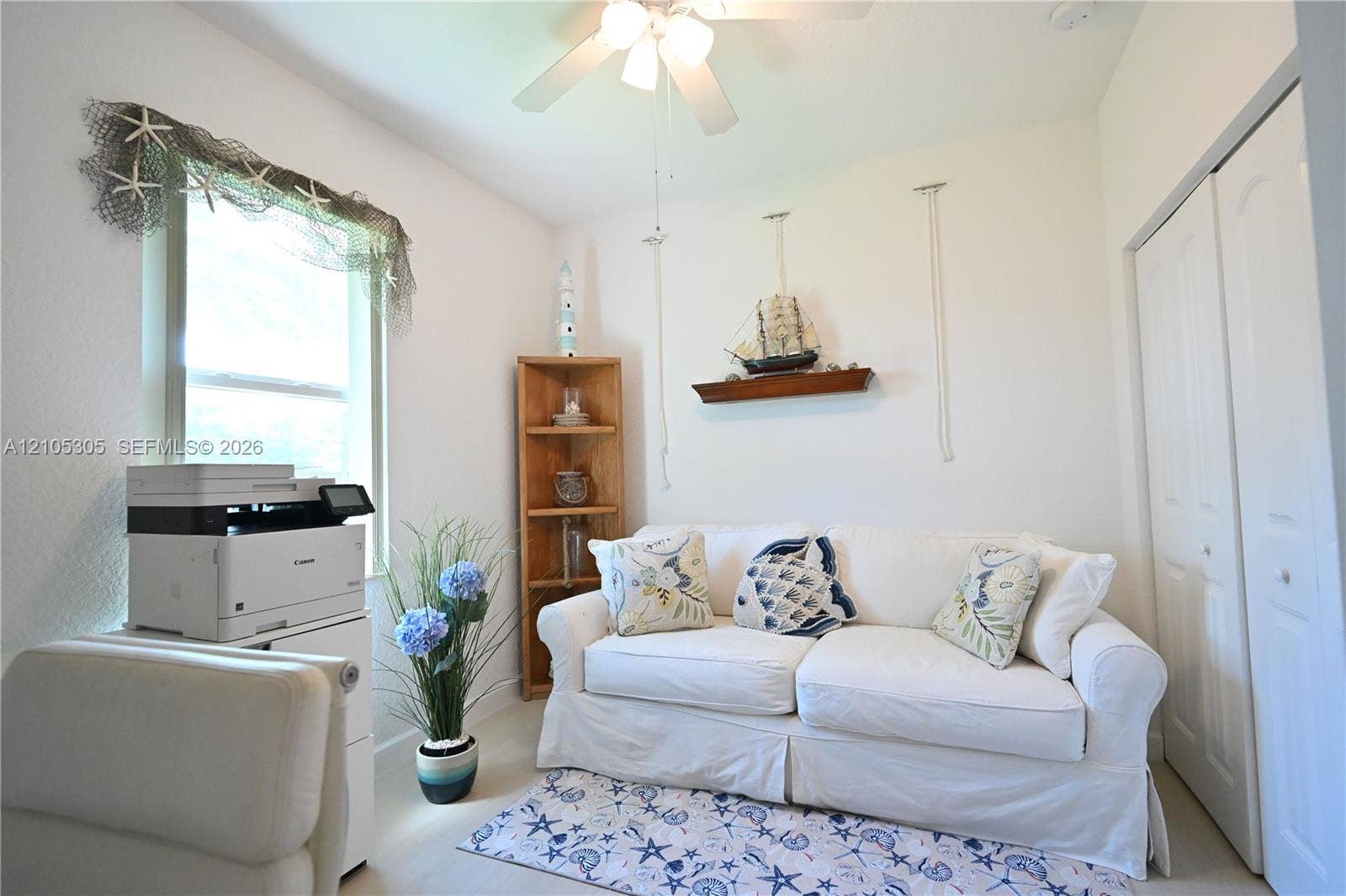 White walls, light-toned flooring, and a ceiling fan