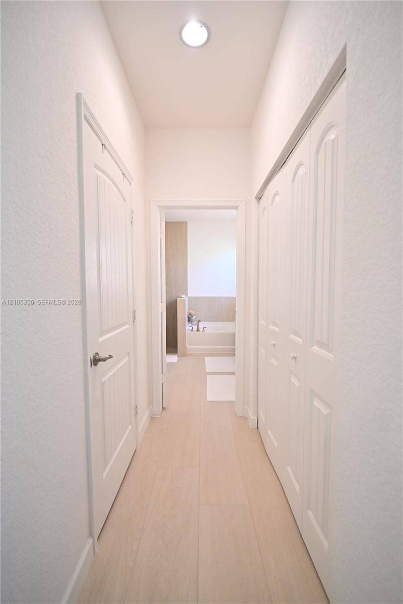 Recessed ceiling light, paneled interior doors, wood-finish flooring, bi-fold closet doors, and light wall finishes